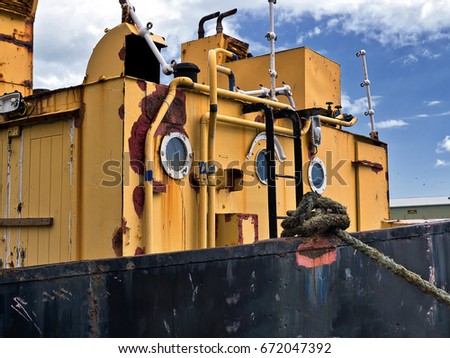 Rusting hulk moored to quay
 Royalty-Free Stock Photo #672047392