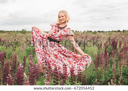 A girl in a lupine field