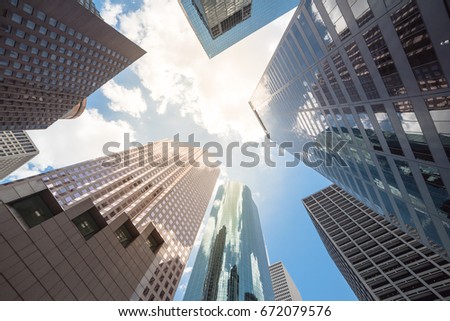Upward view of skyscrapers against a cloud blue sky in the business district area of downtown Houston, Texas, US.