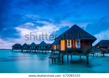 Water villas on tropical caribbean island, Maldives Royalty-Free Stock Photo #672085525