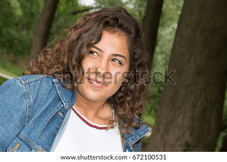 curly girl in park in summer day