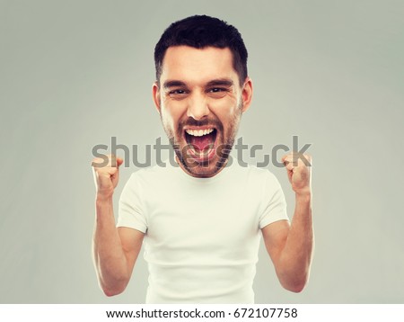 emotion, success, gesture and people concept - young man celebrating victory and screaming over gray background  (funny cartoon style character with big head)