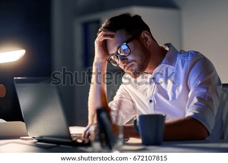 business, overwork, people, deadline and technology concept - stressed businessman in glasses with laptop computer thinking at night office Royalty-Free Stock Photo #672107815