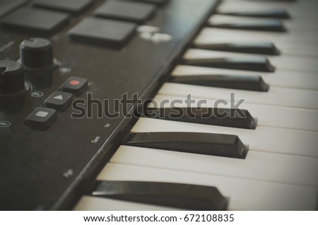 Piano or electone midi keyboard, electronic musical synthesizer white and black key. Close up. Vintage effect, instagram filter style.