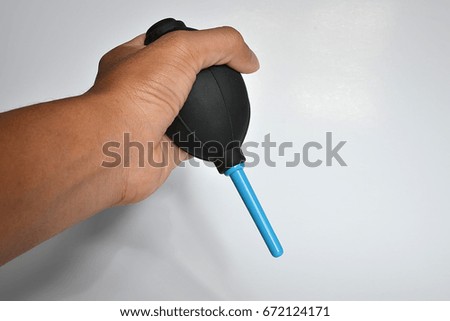 Hand hold air blower for cleaning the camera lens isolated on white background.
