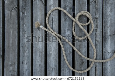 loose sailing rope on wooden planks