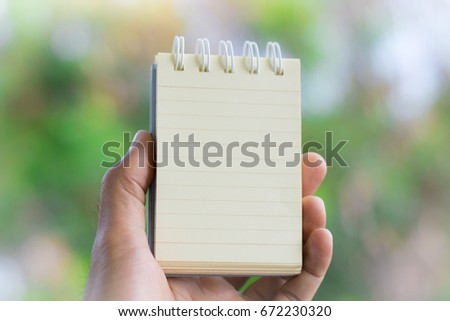 white paper or book on the tree bokeh background using wallpaper and background for  note work.