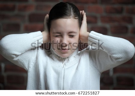 girl with his hands covering his ears