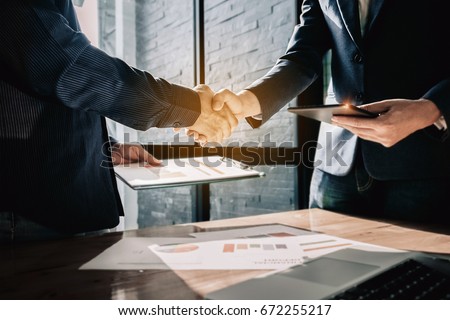 Young businessmen collaborate with partners to increase their business investment network for  Plans to improve quality next month in their office. agreement concept. Royalty-Free Stock Photo #672255217
