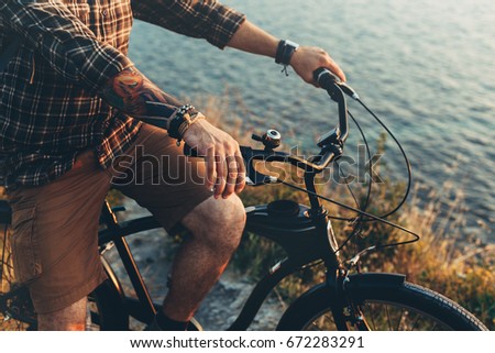 Unrecognizable Young Man Standing With Bike On Coast And Enjoying View of Nature Sunset Vacation Traveling Relaxation Resting Concept