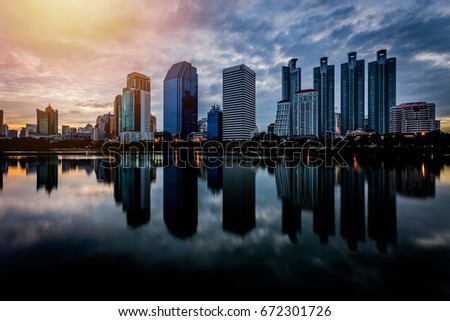 City building with water reflection before sunset background