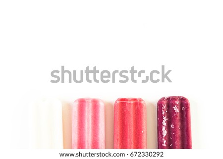 Multicolored fruit ice cream bars on a white background.