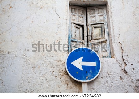 The old door and road sign