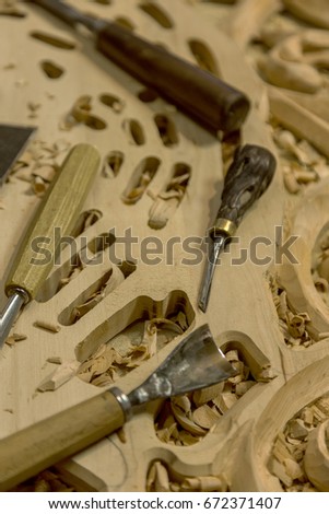 Woodworking. Joinery works. Woodcarving. Workplace of woodcarver, tools on a wooden background close-up. Use as background folk crafts. Wood carving