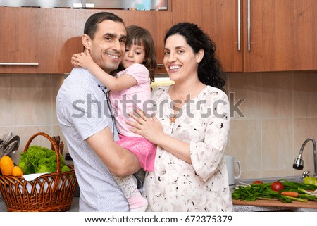 pregnant woman and man in kitchen interior with fresh fruits and vegetables, healthy food concept, happy couple