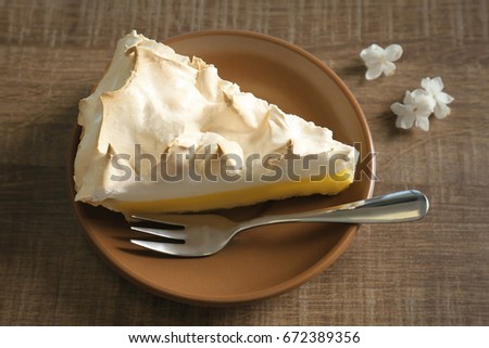 Piece of delicious lemon meringue pie on plate