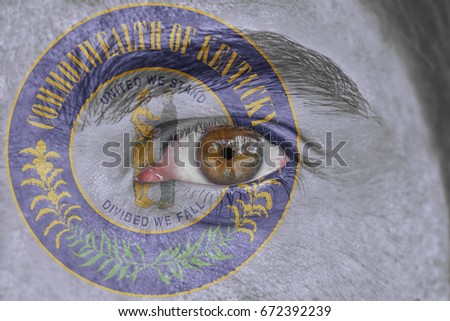 Human face and eye painted with US state seal flag of Kentucky