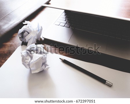 Businesses have both been successful and fail. The picture of paper, pencil, laptop, and hand gesture above wooden table.