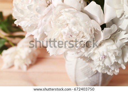 Closeup view of peonies on blurred background