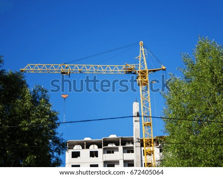 construction in the city. crane at construction site against a blue sky day
