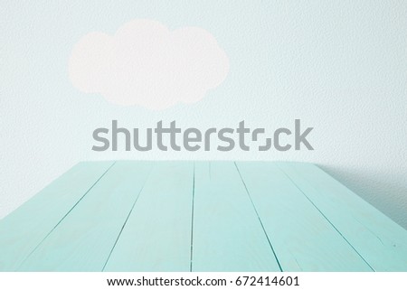 Heavenly blue wall and empty turquoise table.