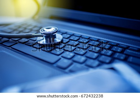 Computer or data analysis - Stethoscope over notebook  keyboard toned in blue Royalty-Free Stock Photo #672432238
