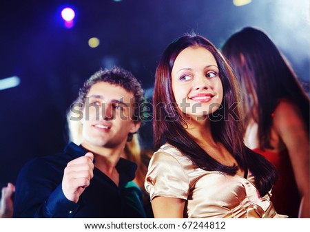 Image of pretty girl dancing on background of teenage friends