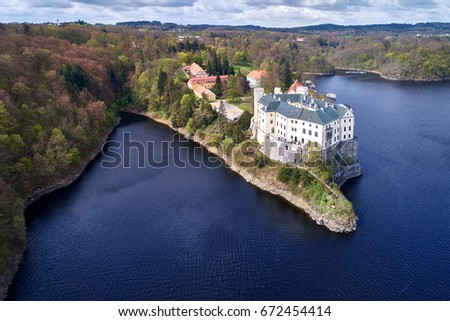Aerial view on czech romantic, gothic chateâu Orlik, situated on rock outcrop above  Orlik reservoir in beautiful spring nature. Romantic,royal Schwarzenberg castle above water level. Czech landscape.