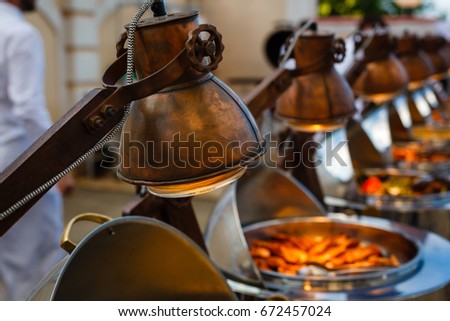 Infrared lamp to warm up food. buffet table