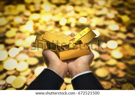 Gold bar on hand Royalty-Free Stock Photo #672521500