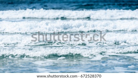 Big surfing ocean sea waves on sandy beach. Background landscape picture strong waves of Atlantic ocean in Spain. Ready for surfing.