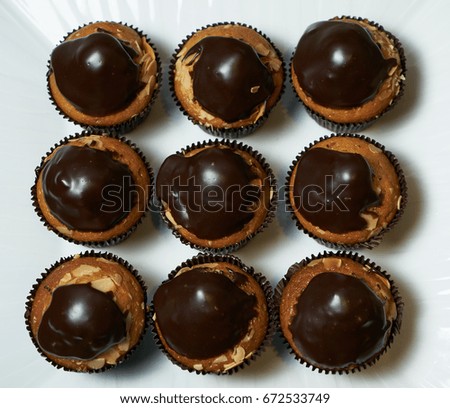 Set of tasty chocolate frosting cakes isolated on white. Top view