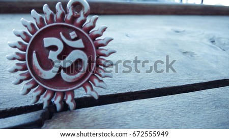 om pendent on wood texture background and greeting 