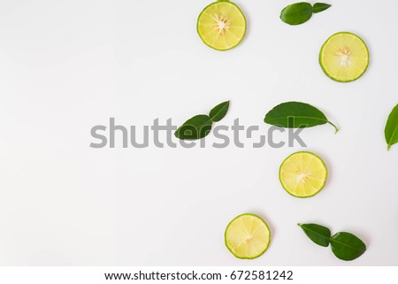 Lemon sliced and lemon leaves in white background. Royalty-Free Stock Photo #672581242