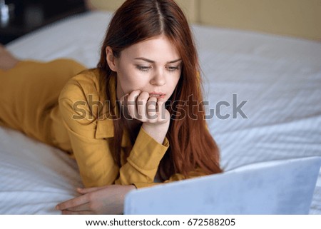 Woman in bed with laptop                               