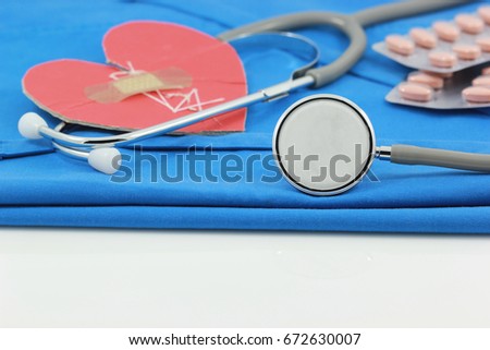 Stethoscope and broken red heart on blue doctor coat, Medicine concept