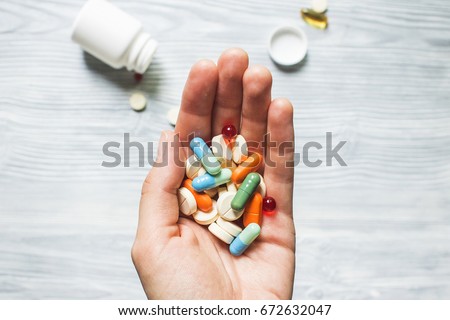 Colorful pills and medicines in the hand Royalty-Free Stock Photo #672632047