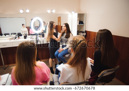 professional makeup teacher training her student girl to become makeup artist. Makeup tutorial lesson at beauty school. Master class. Real people. 