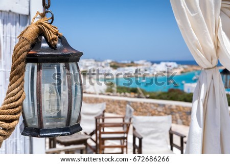 Old lantern decoration with white curtain on a Greek cycladic island, Greece