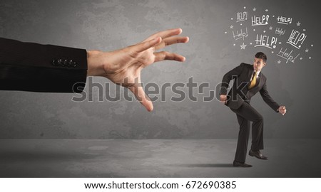 Business person running away from big hand while asking for help concept on background