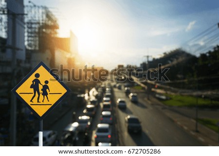 Traffic sign, school sign on Cars on the road bokeh