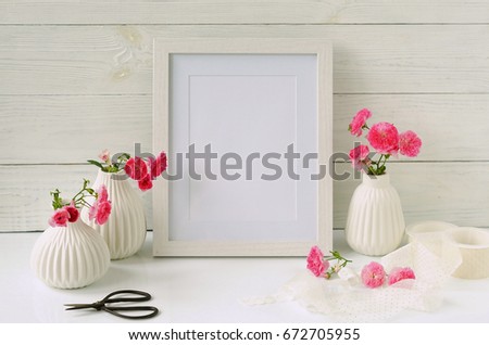White frame mockup with pink roses. Copy space