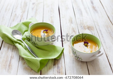 Puree soup, made from orange pumpkin, sweet potatoes and carrots, served with sour cream