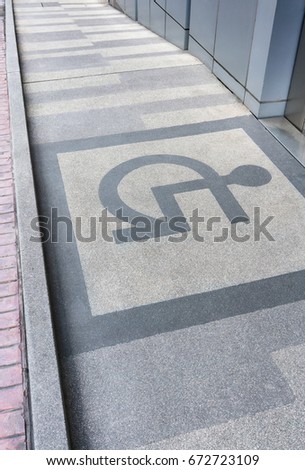 Ramped access, using wheelchair ramp with information sign on floor background for disabled people.