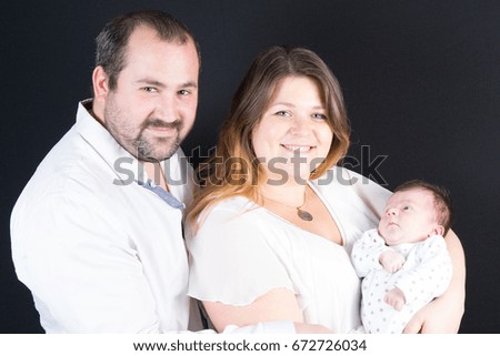 Family portrait: mother, father and newborn baby