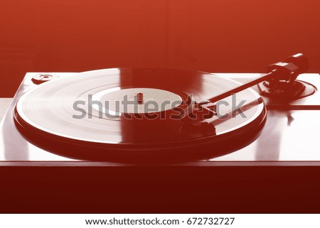 Vintage record player with vinyl disc, close-up. warm sunlight