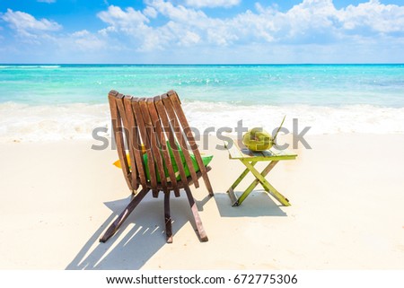 Playa del Carmen - relaxing on chair at paradise beach and city at caribbean coast of Quintana Roo, Mexico Royalty-Free Stock Photo #672775306