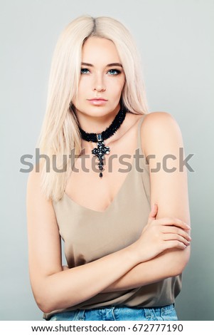 Glamorous Woman Fashion Model with Blonde Hair, Makeup and Necklaces. Portrait of Beautiful Girl