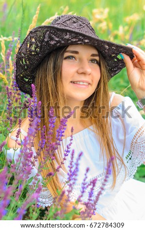 young girl portrait . a slender girl with a beautiful smile and a cowboy hat, close-up, macro. good skin , brown eyes