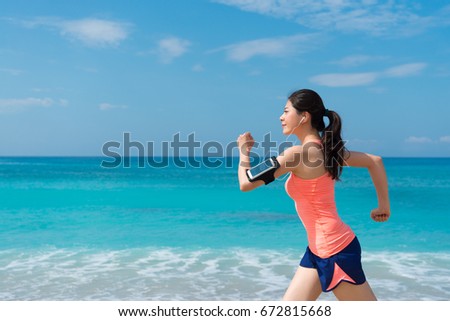 closeup photo of smiling happy girl traveler running on seaside enjoying beautiful landscape during summer vacation journey.